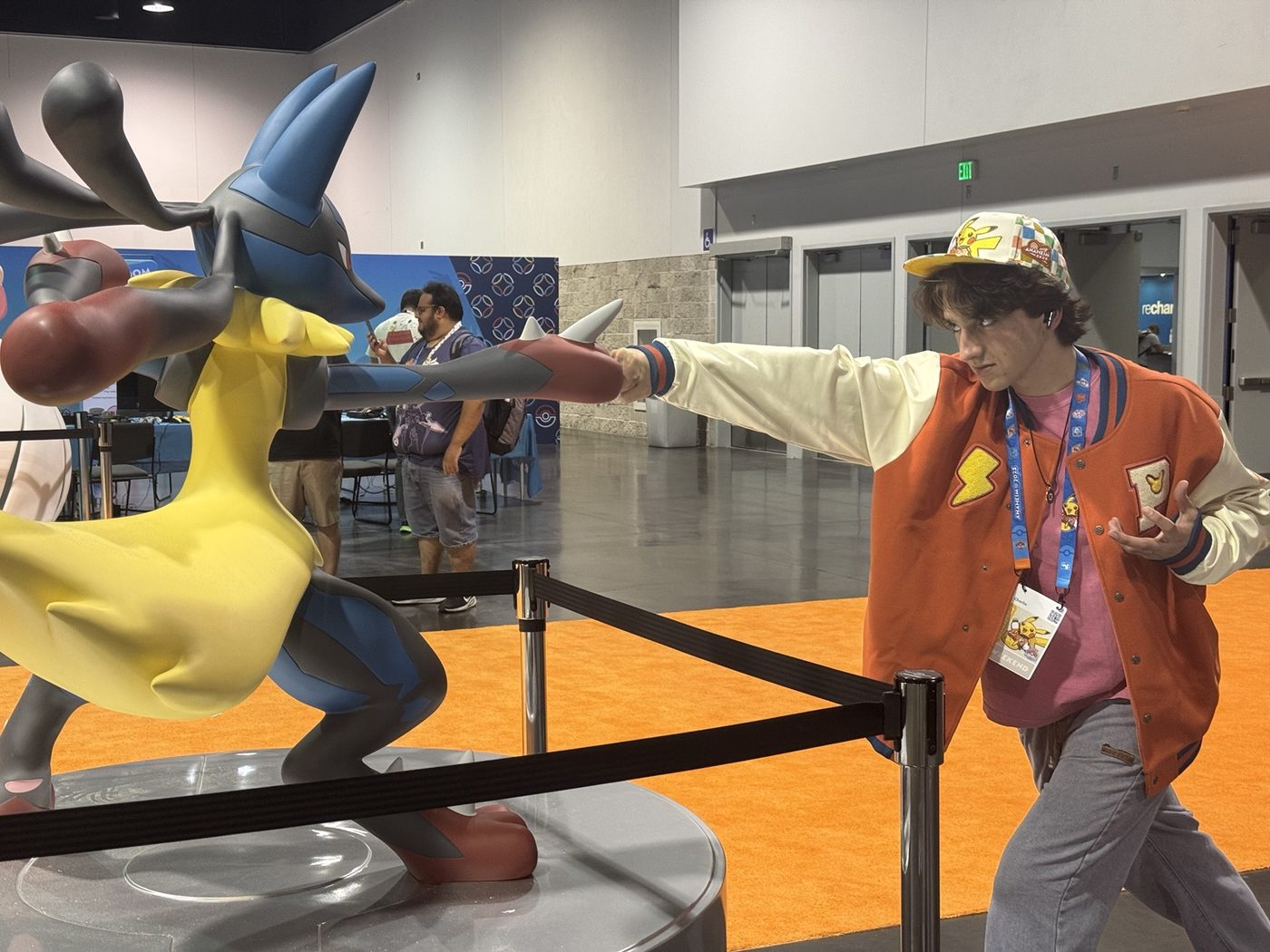 Charlie posing with a Lucario display at the 2025 Pokémon World Championships